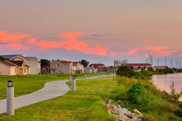 Houses On The Water With A Sunset